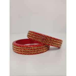 Red bangles with yellow cross design